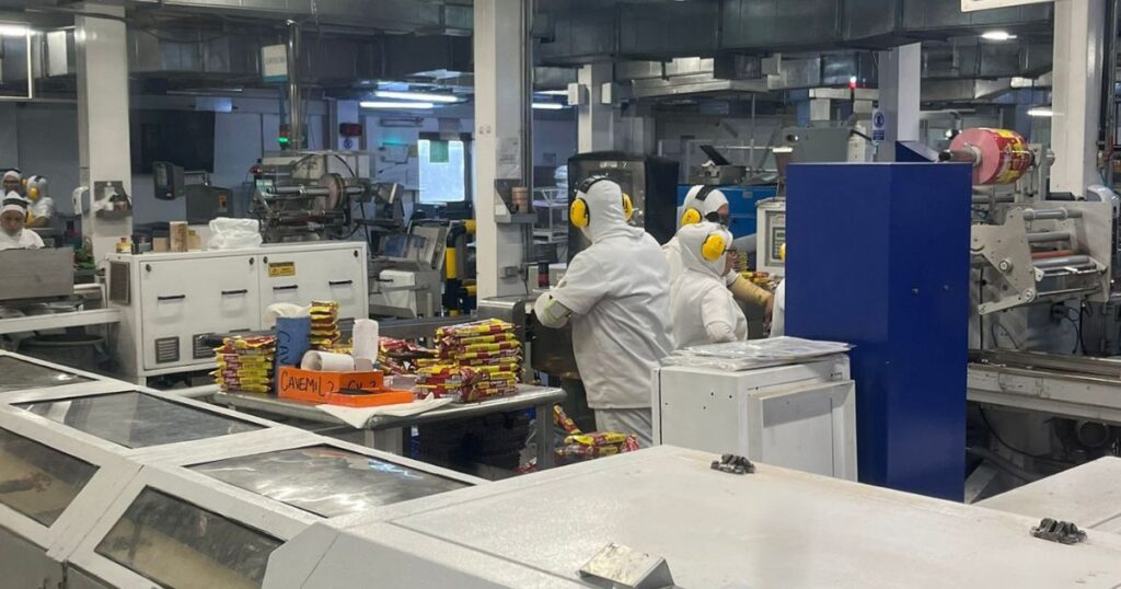 People dressed in white working in a chocolate factory