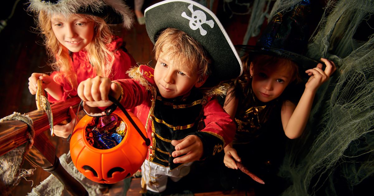 3 children in fancy dress trick or treating